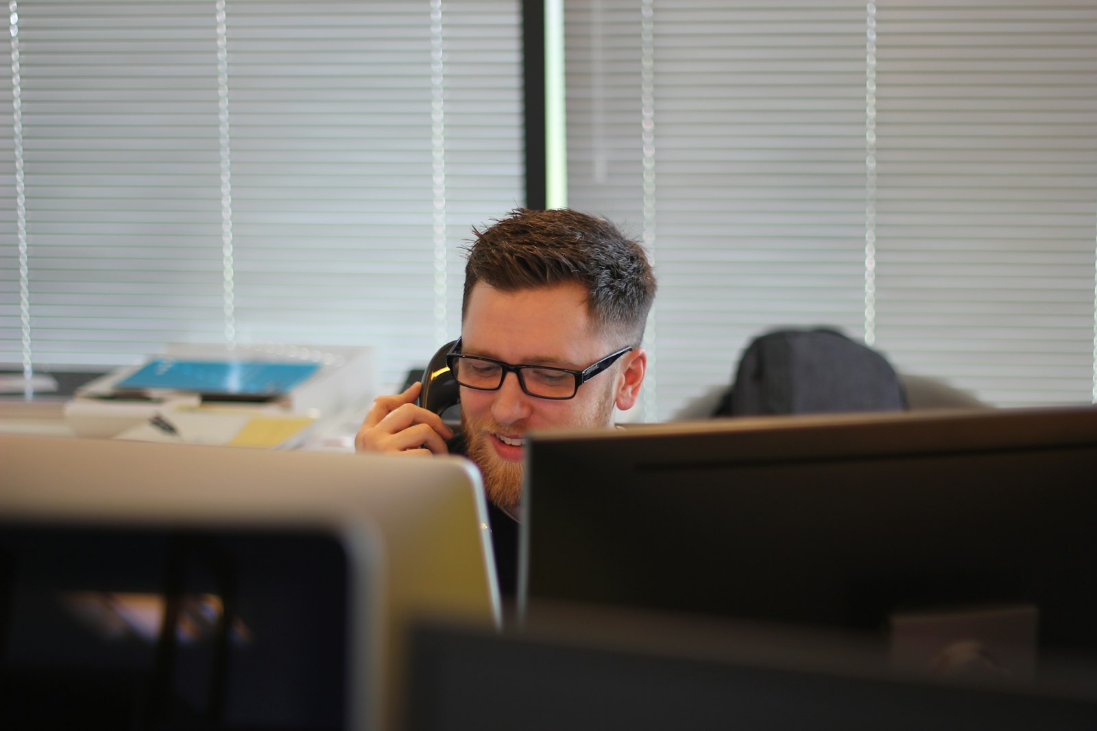 Business owner answering a customer call at their desk